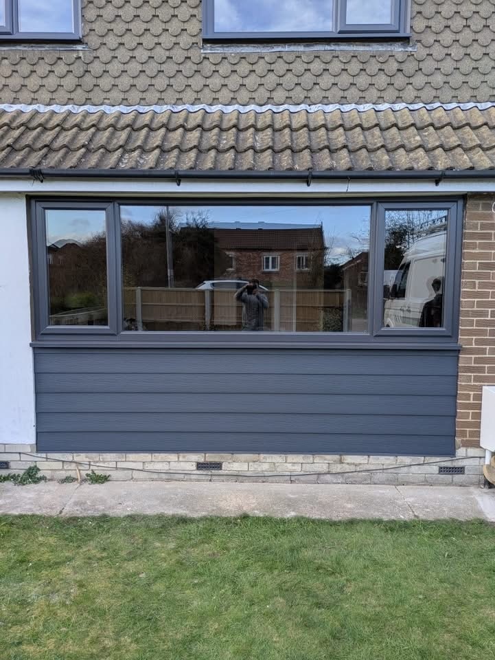 Anthracite grey window and matching cladding on a residential property