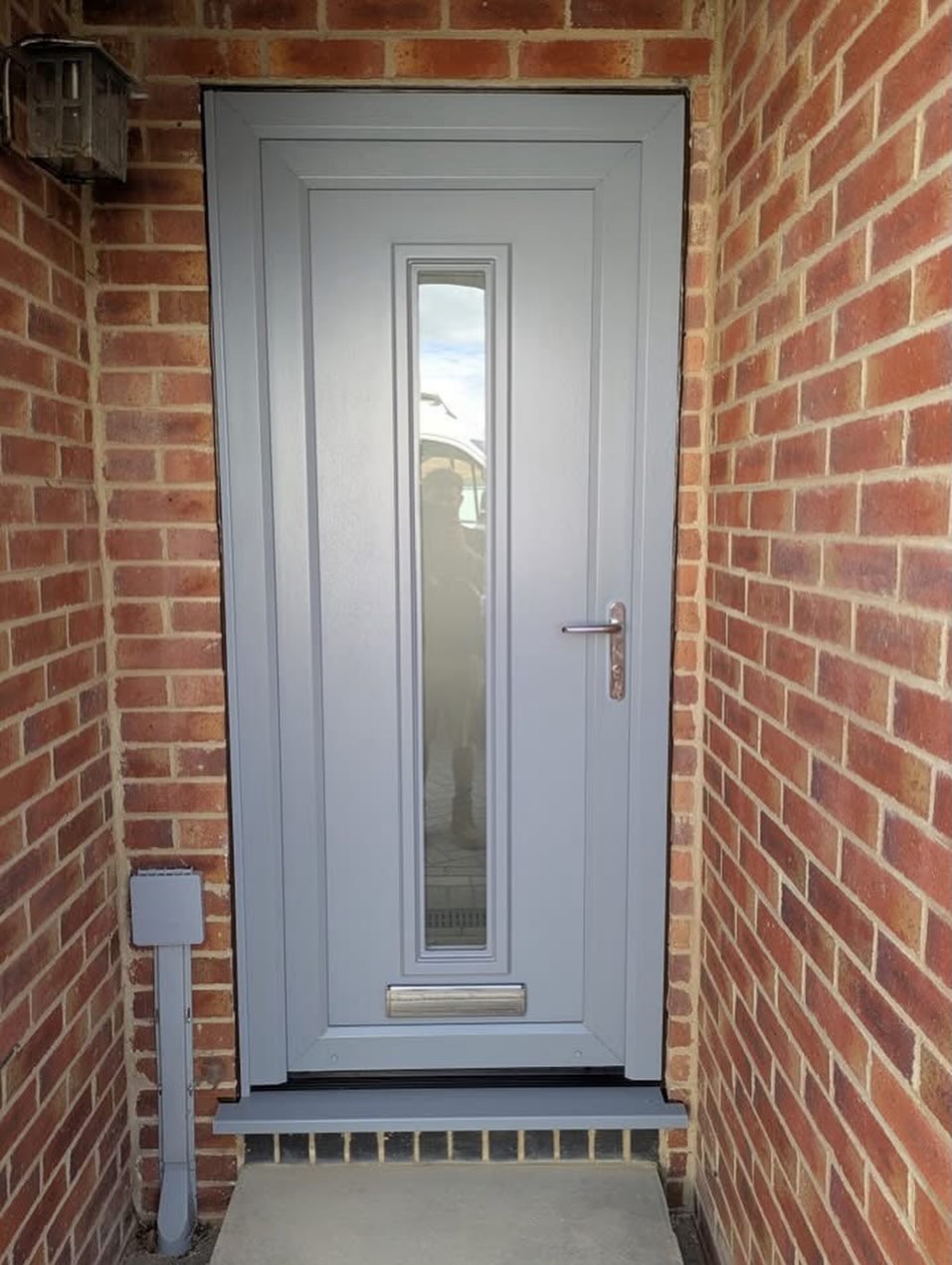 RAL 7001 Silver Grey uPVC entrance door with glazed detailing
