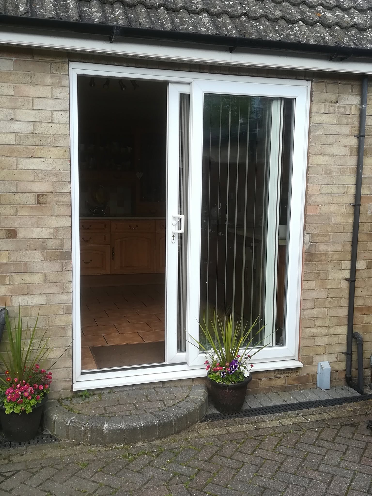 White uPVC sliding patio door on a brick property