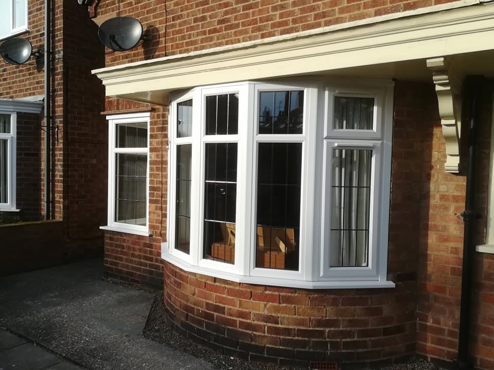 White uPVC bay window on a brick property